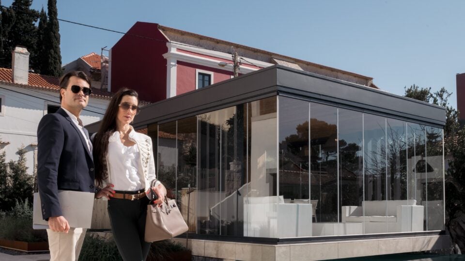Stylish couple posing in front of modern architecture.