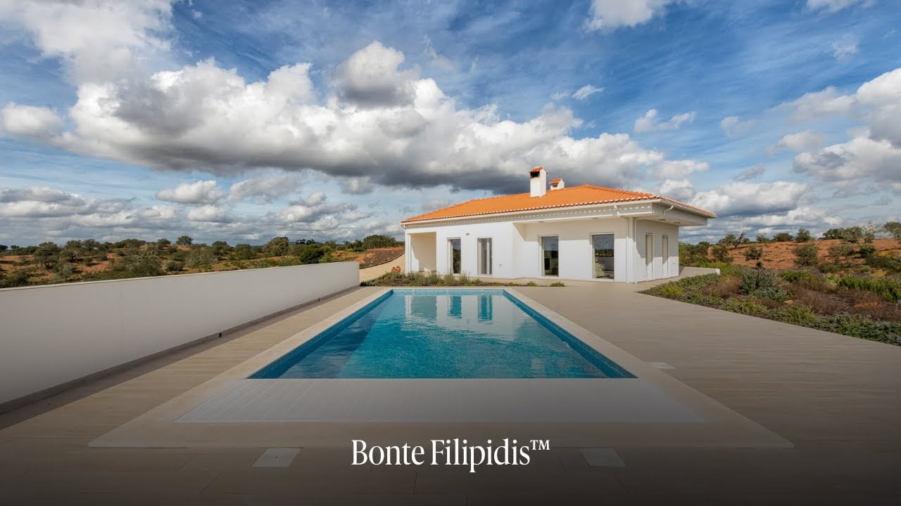 Modern villa with pool and scenic landscape.