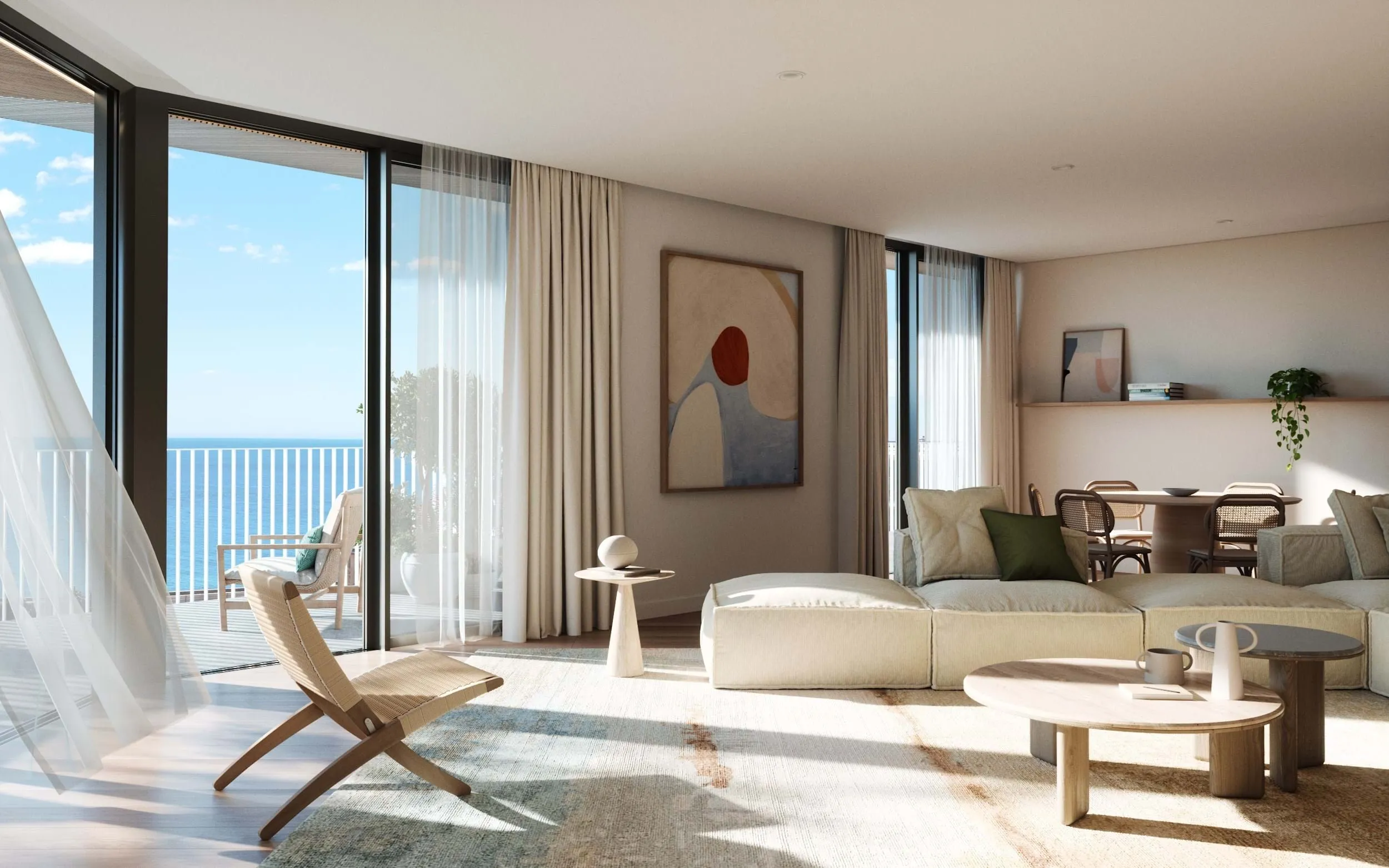 A bright and airy living room with minimalist decor, featuring a soft beige sectional sofa, light wood furniture, abstract wall art, and large glass doors leading to a balcony with ocean views. Sheer curtains and natural light enhance the serene ambiance.