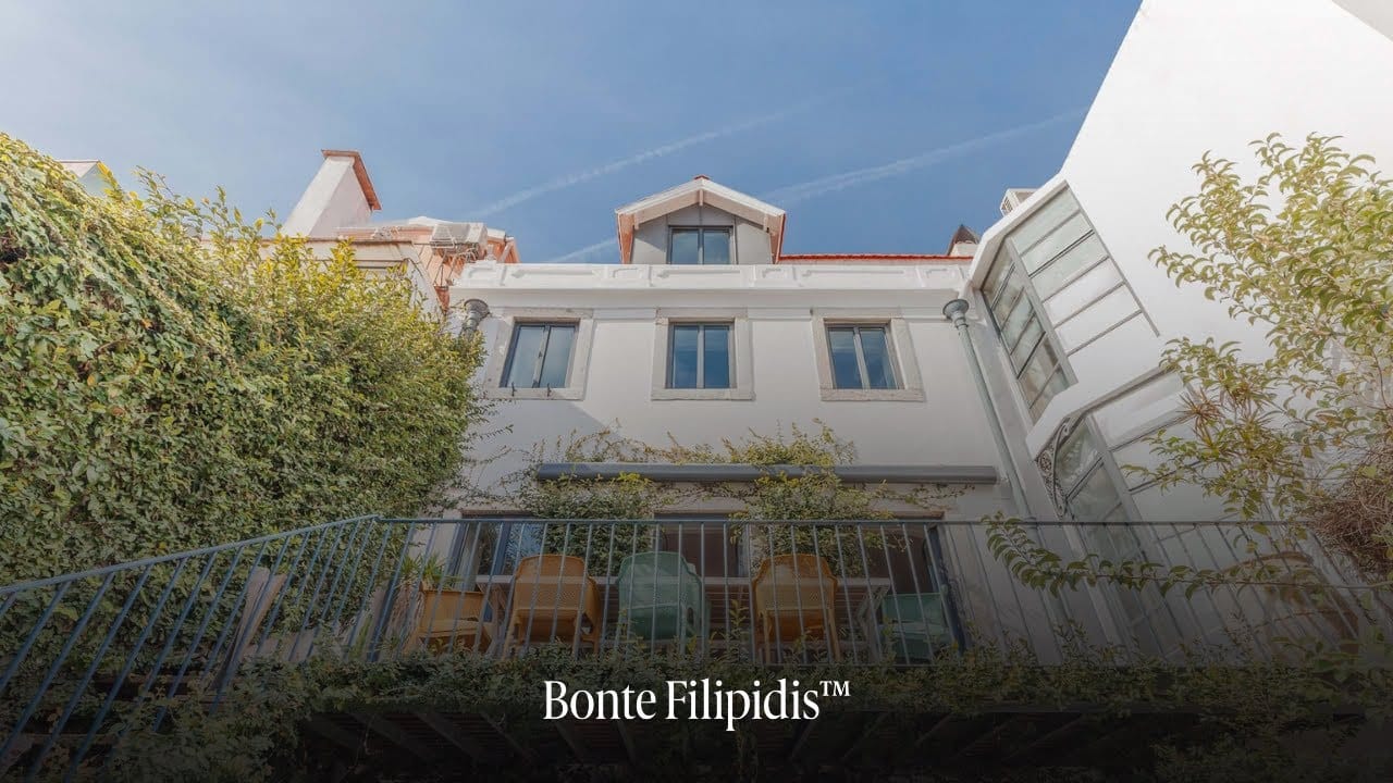 Stylish building with greenery and modern architecture.