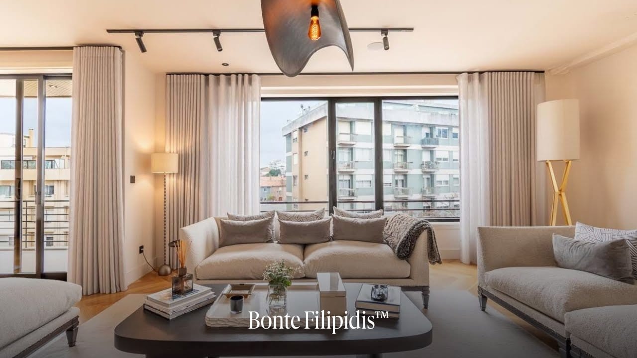 Stylish living room with large windows and curtains.