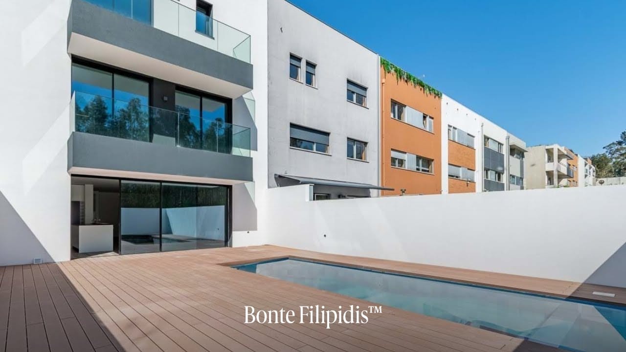 Modern house with a swimming pool and patio.