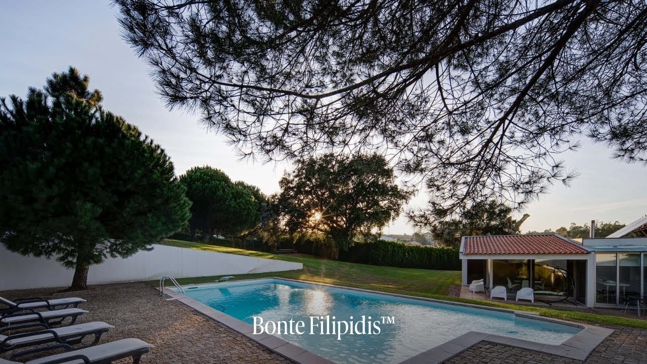 Serene outdoor pool surrounded by lush greenery.