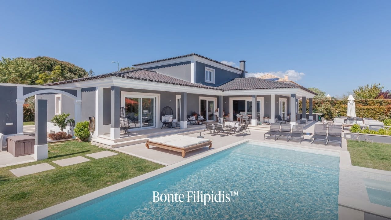 Modern villa with pool and outdoor seating area.