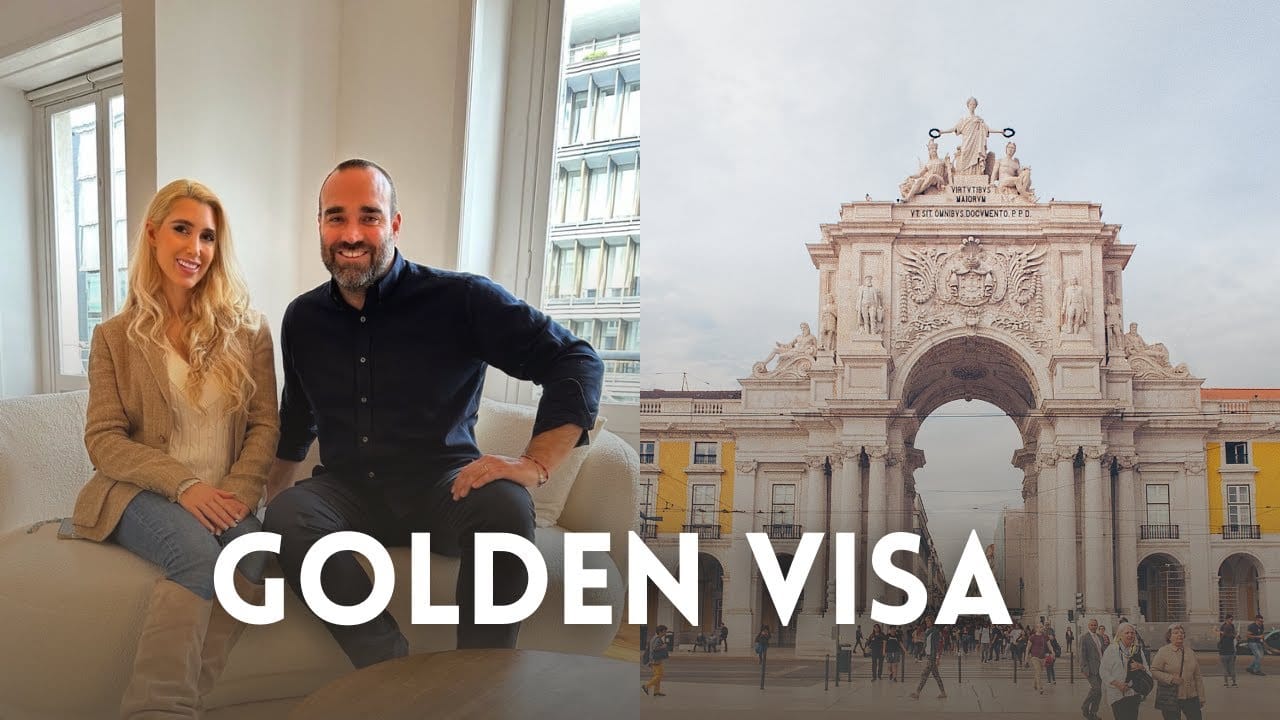 Couple discussing Golden Visa near historic arch.